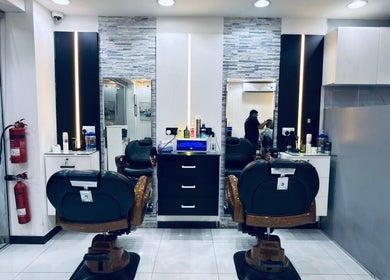 Chic interior of Kenchie Gents Salon Nahda 2 Branch, Dubai, AE, featuring modern styling chairs and sleek decor.