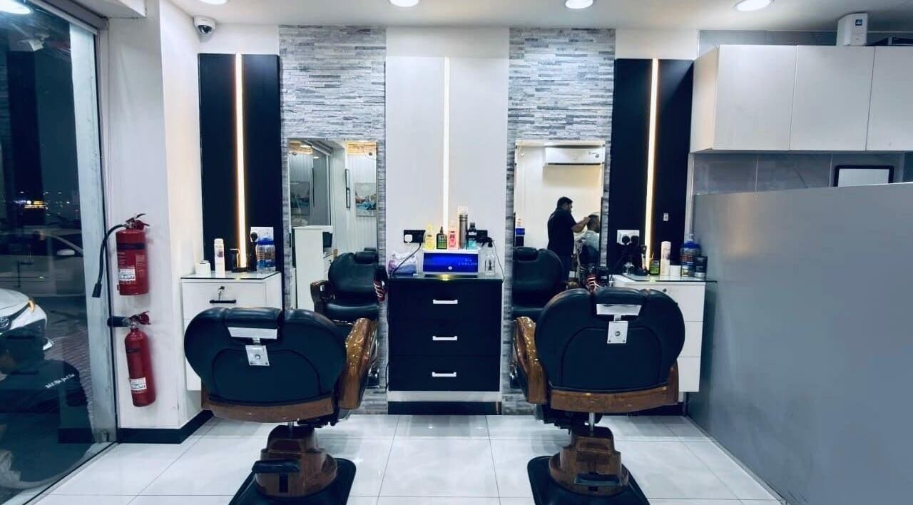 Interior of Kenchie Gents Salon Nahda 2 Branch, Dubai, AE showcasing stylish barber chairs and modern decor.