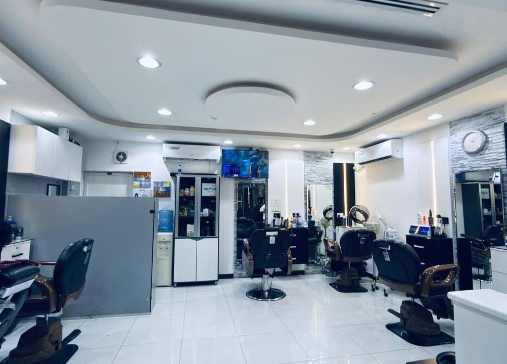 Interior of Kenchie Gents Salon Nahda 2 Branch, Dubai, AE, showcasing modern styling chairs and sleek decor.