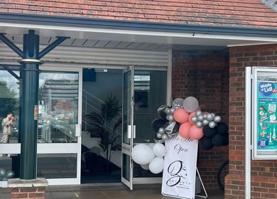Entrance of Encanto Salon in Spalding, United Kingdom, GB with decorative balloons.