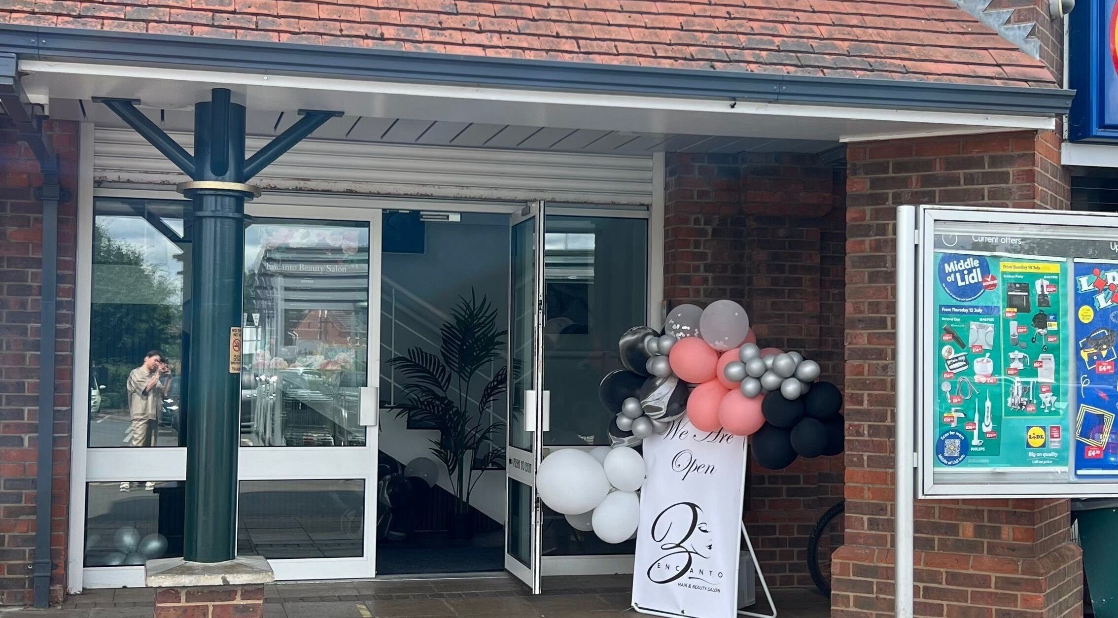 Entrance of Encanto Salon in Spalding, United Kingdom, GB with decorative balloons.