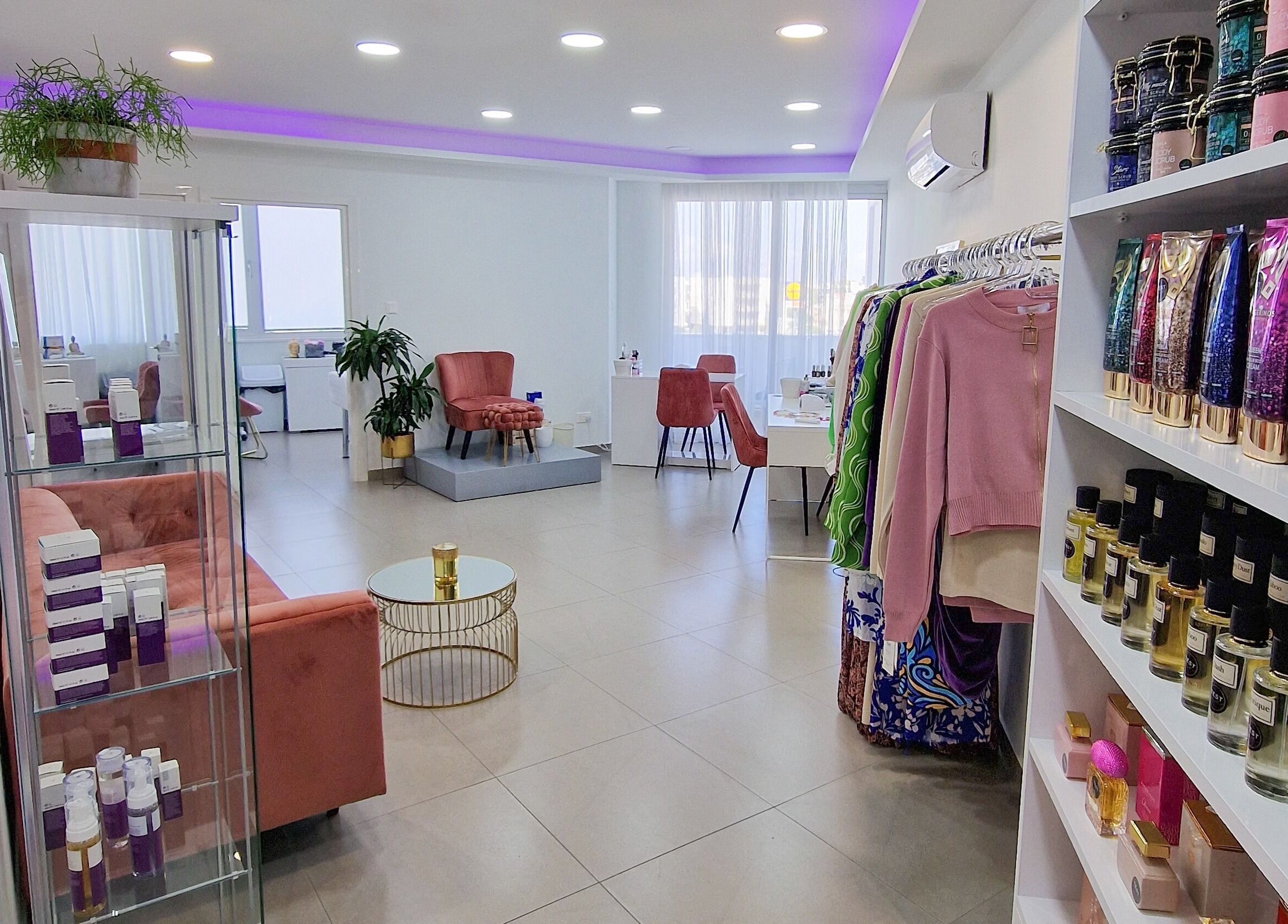 Modern interior of Nathal Lakatamia in Lakatamia, Nicosia, CY showcasing beauty products and pink velvet seating.