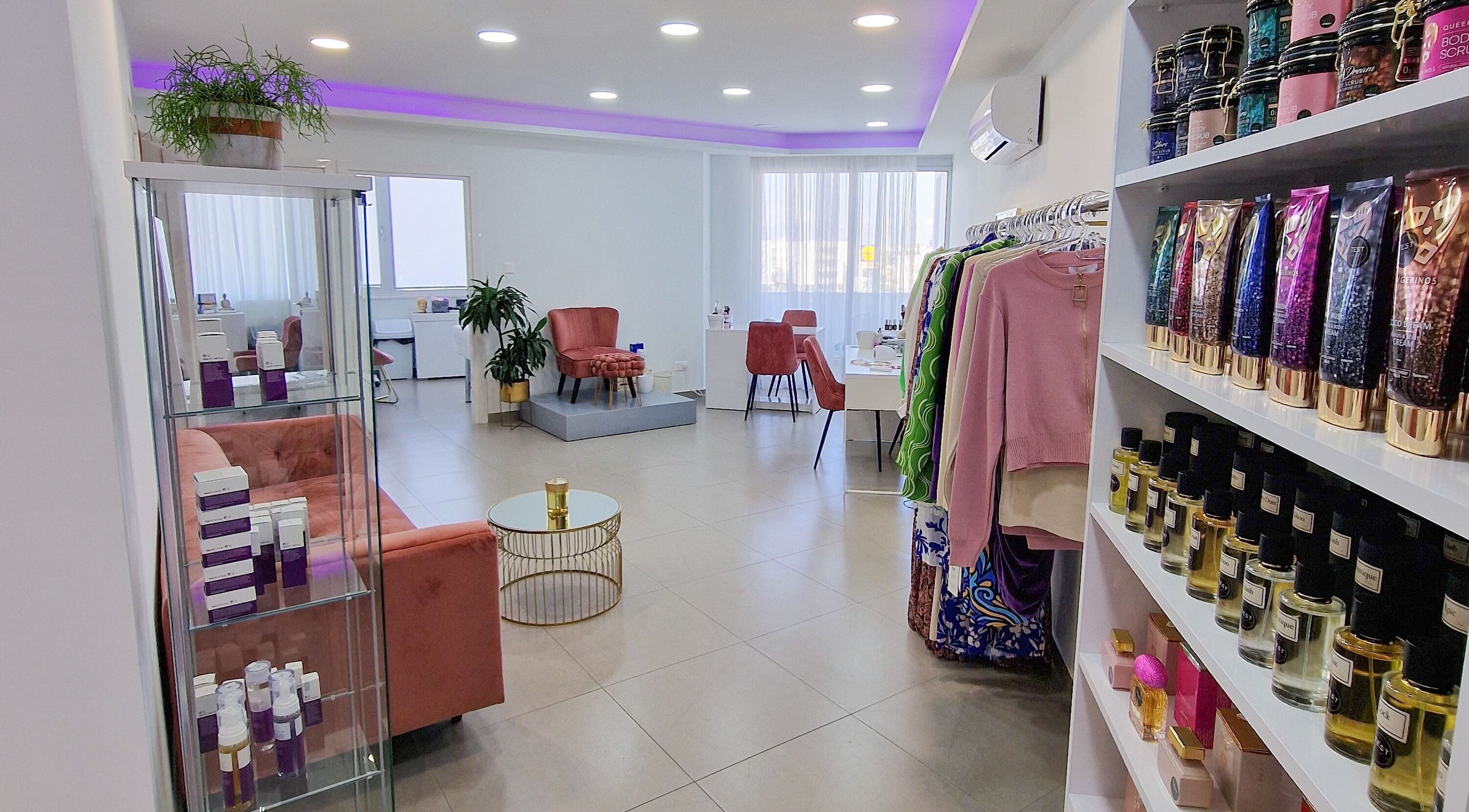 Modern interior of Nathal Lakatamia in Lakatamia, Nicosia, CY showcasing beauty products and pink velvet seating.