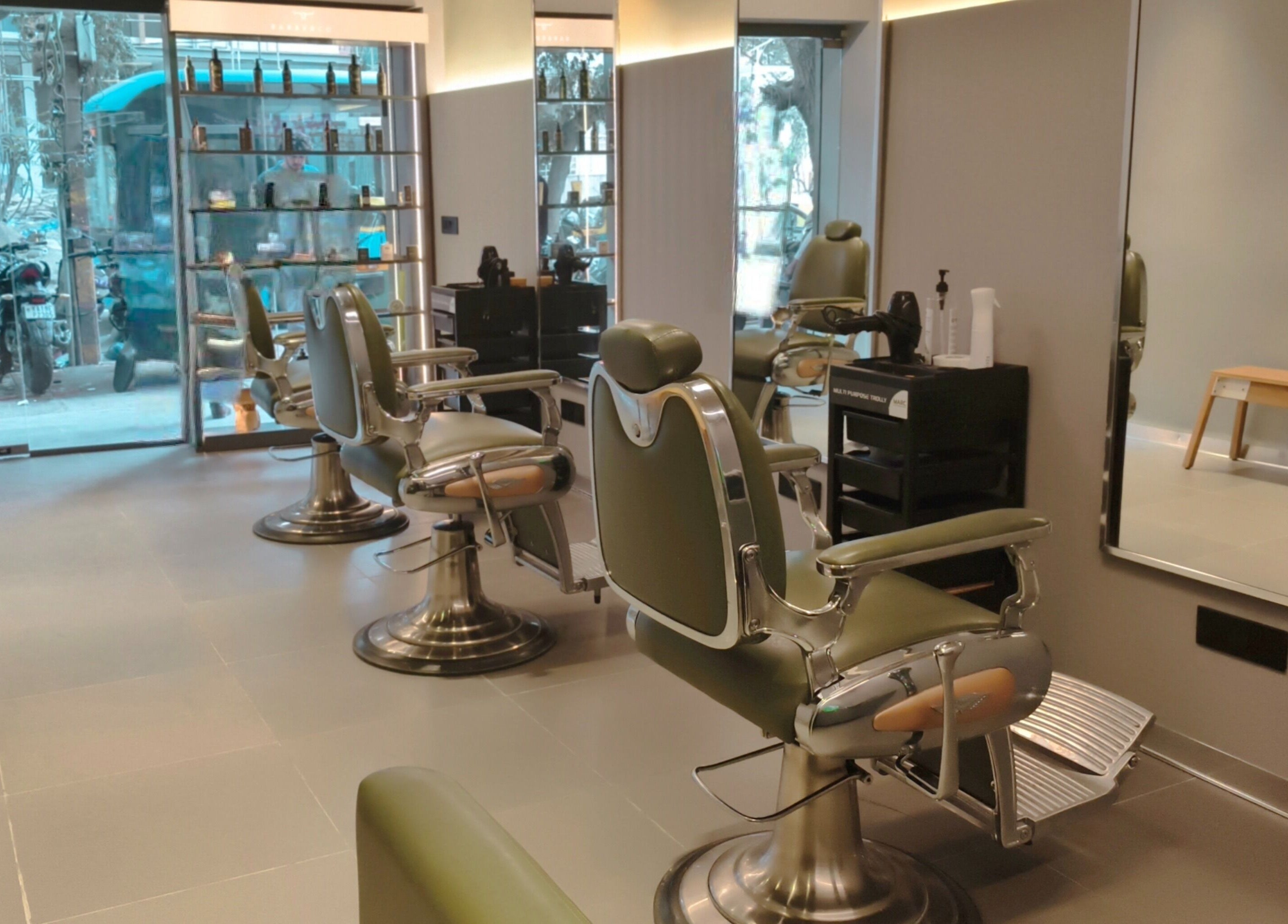 BarberCo - Banashankari in Bengaluru, Karnataka, IN features stylish green barber chairs and modern decor.