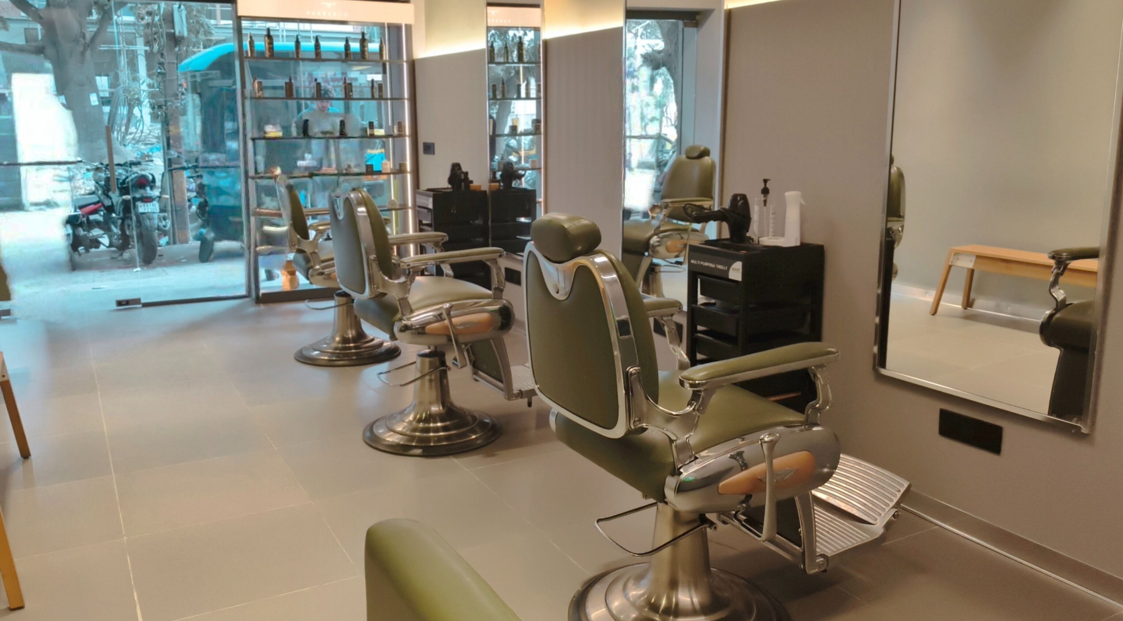 BarberCo - Banashankari in Bengaluru, Karnataka, IN features stylish green barber chairs and modern decor.