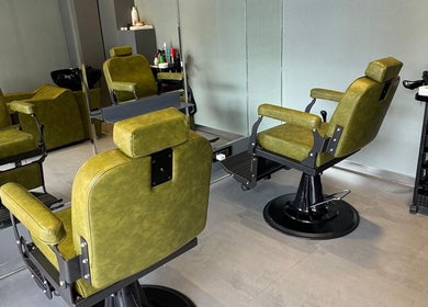 BarberCo - Frazer Town in Bangalore, Karnataka, IN features stylish green barber chairs in a modern room.