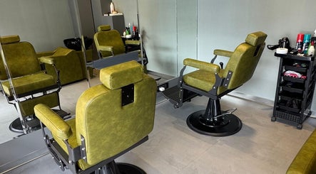 BarberCo - Frazer Town in Bangalore, Karnataka, IN features stylish green barber chairs in a modern room.