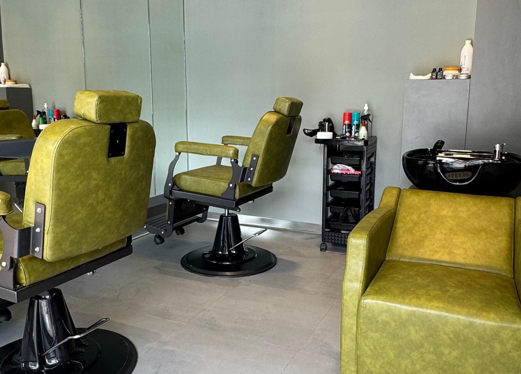 Stylish green barber chairs at BarberCo - Frazer Town, Bangalore, Karnataka, IN, enhancing a sleek modern interior.
