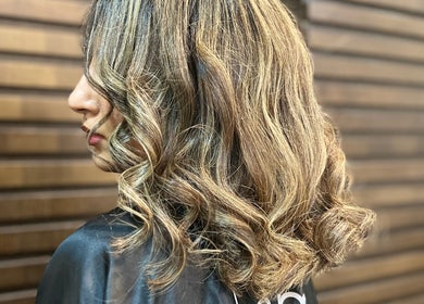 Elegant blonde wavy hairstyle at Elysian Beauty Spa & Ladies Salon, Muscat, Muscat Governorate, OM.