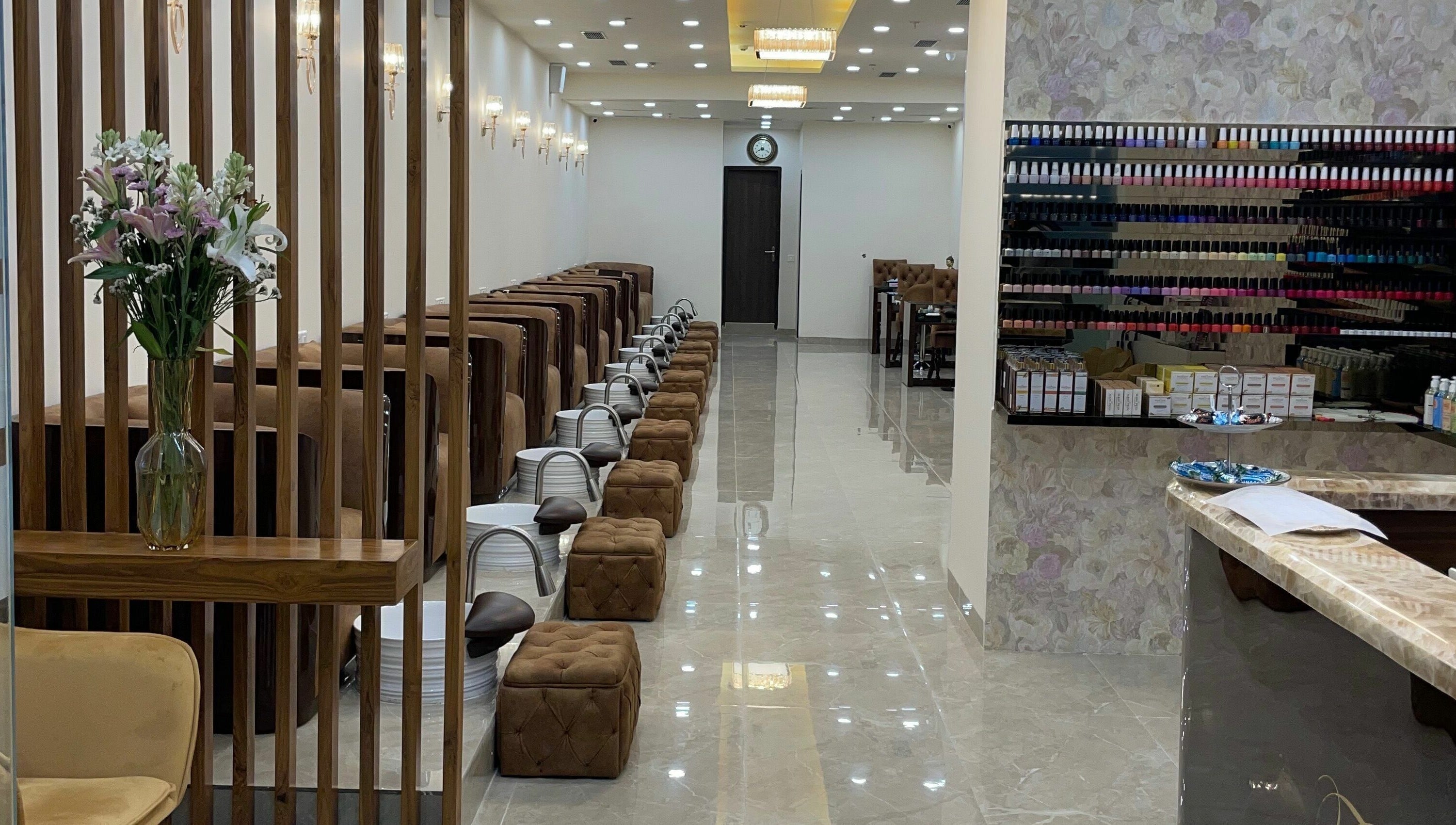 Elegant interiors of The Mani Pedi Spa, South Point Mall, DLF 5, Gurugram, Haryana, IN with plush seating and nail polish display.
