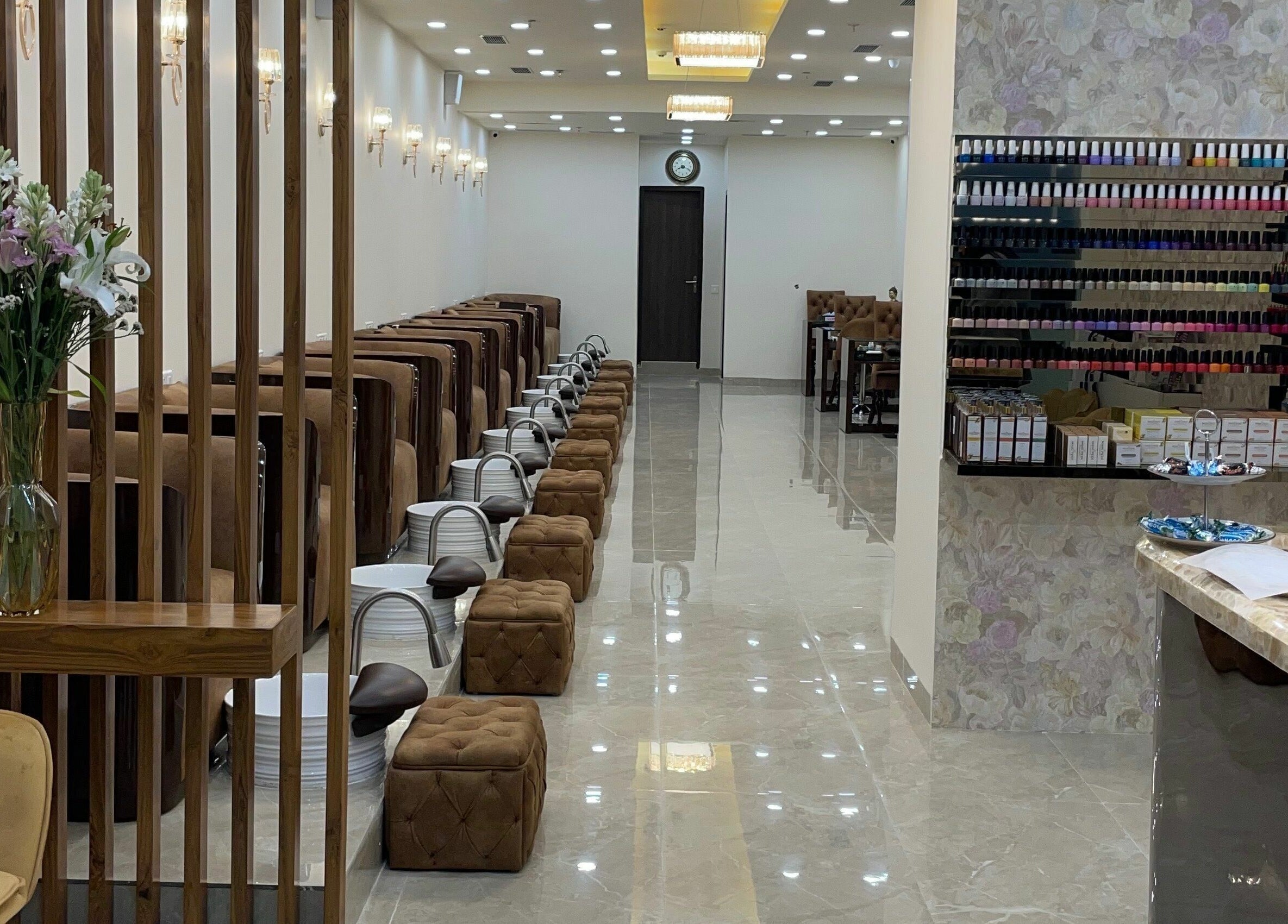 Elegant interiors of The Mani Pedi Spa, South Point Mall, DLF 5, Gurugram, Haryana, IN with plush seating and nail polish display.