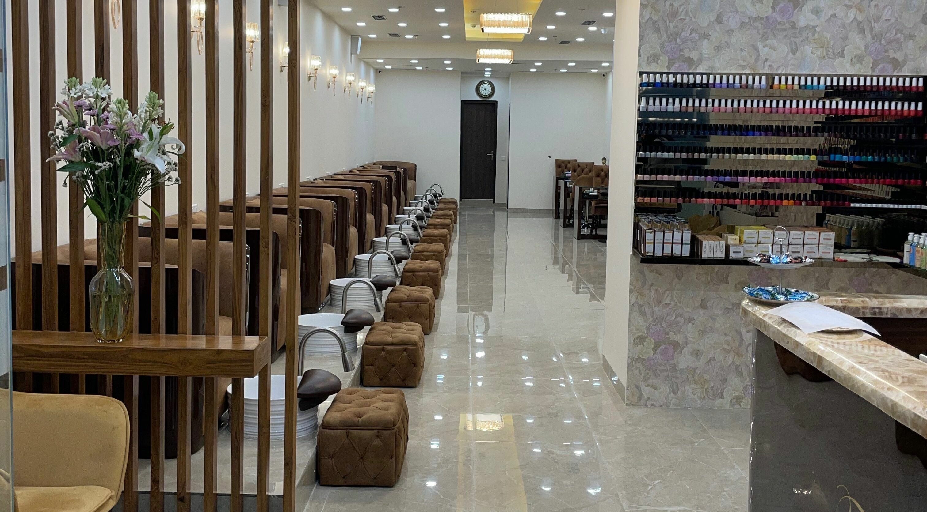Elegant interiors of The Mani Pedi Spa, South Point Mall, DLF 5, Gurugram, Haryana, IN with plush seating and nail polish display.