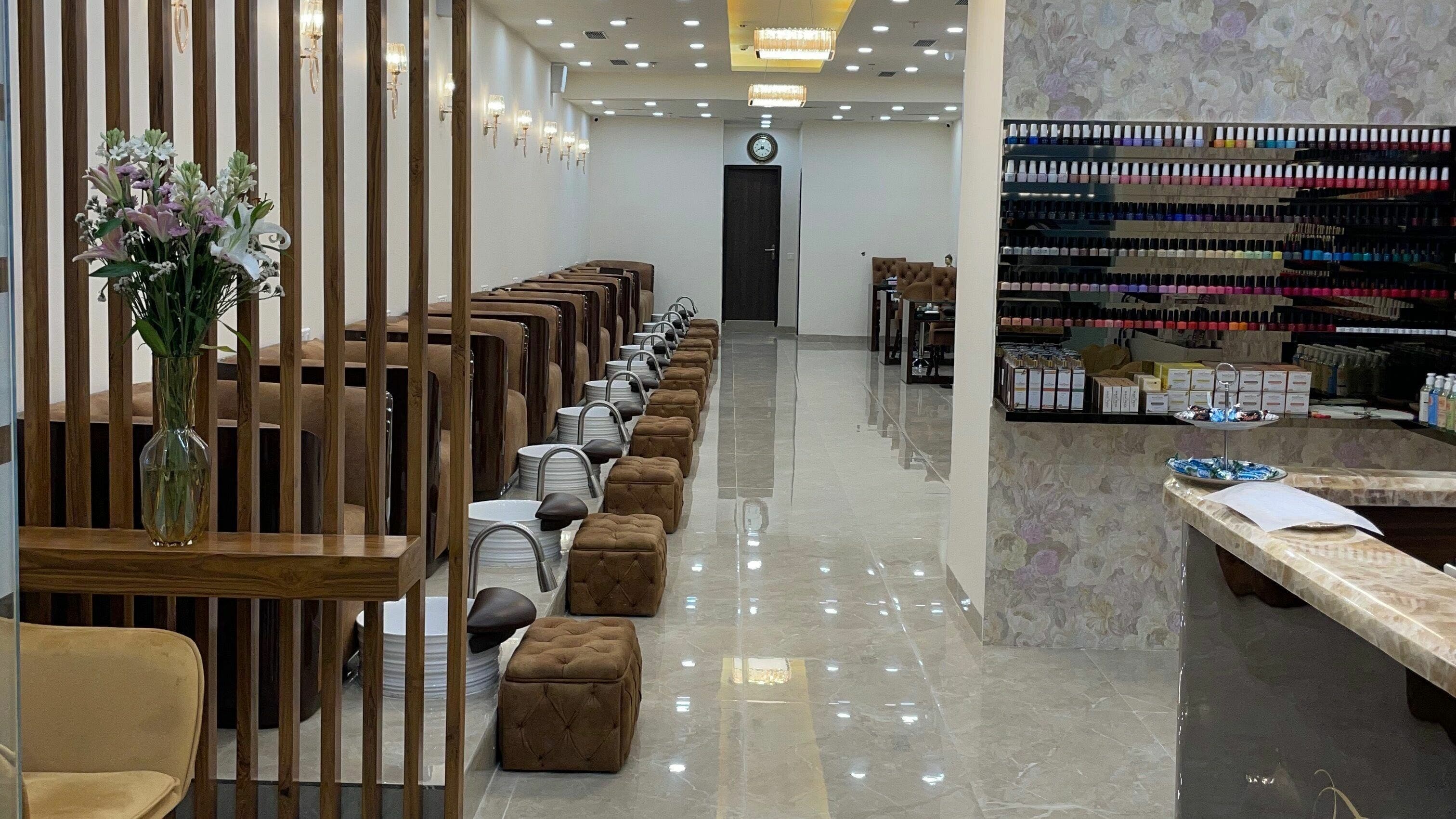 Elegant interiors of The Mani Pedi Spa, South Point Mall, DLF 5, Gurugram, Haryana, IN with plush seating and nail polish display.