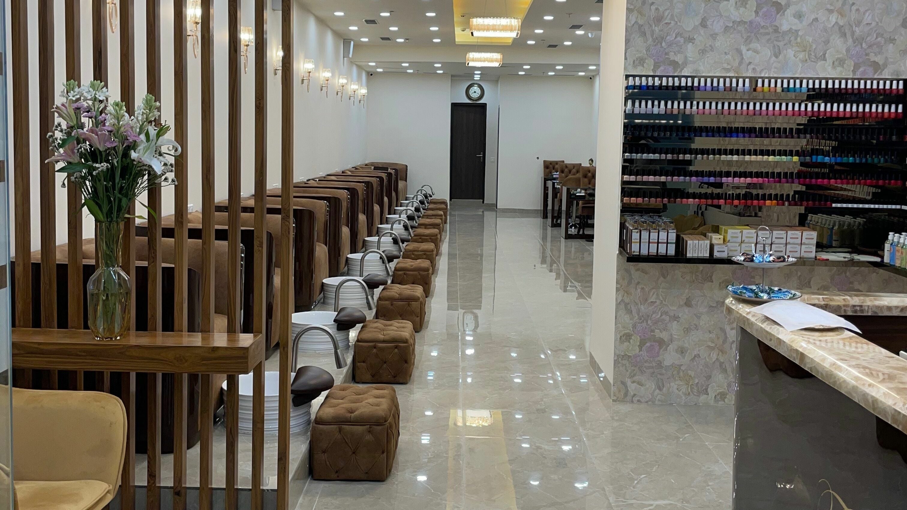 Elegant interiors of The Mani Pedi Spa, South Point Mall, DLF 5, Gurugram, Haryana, IN with plush seating and nail polish display.