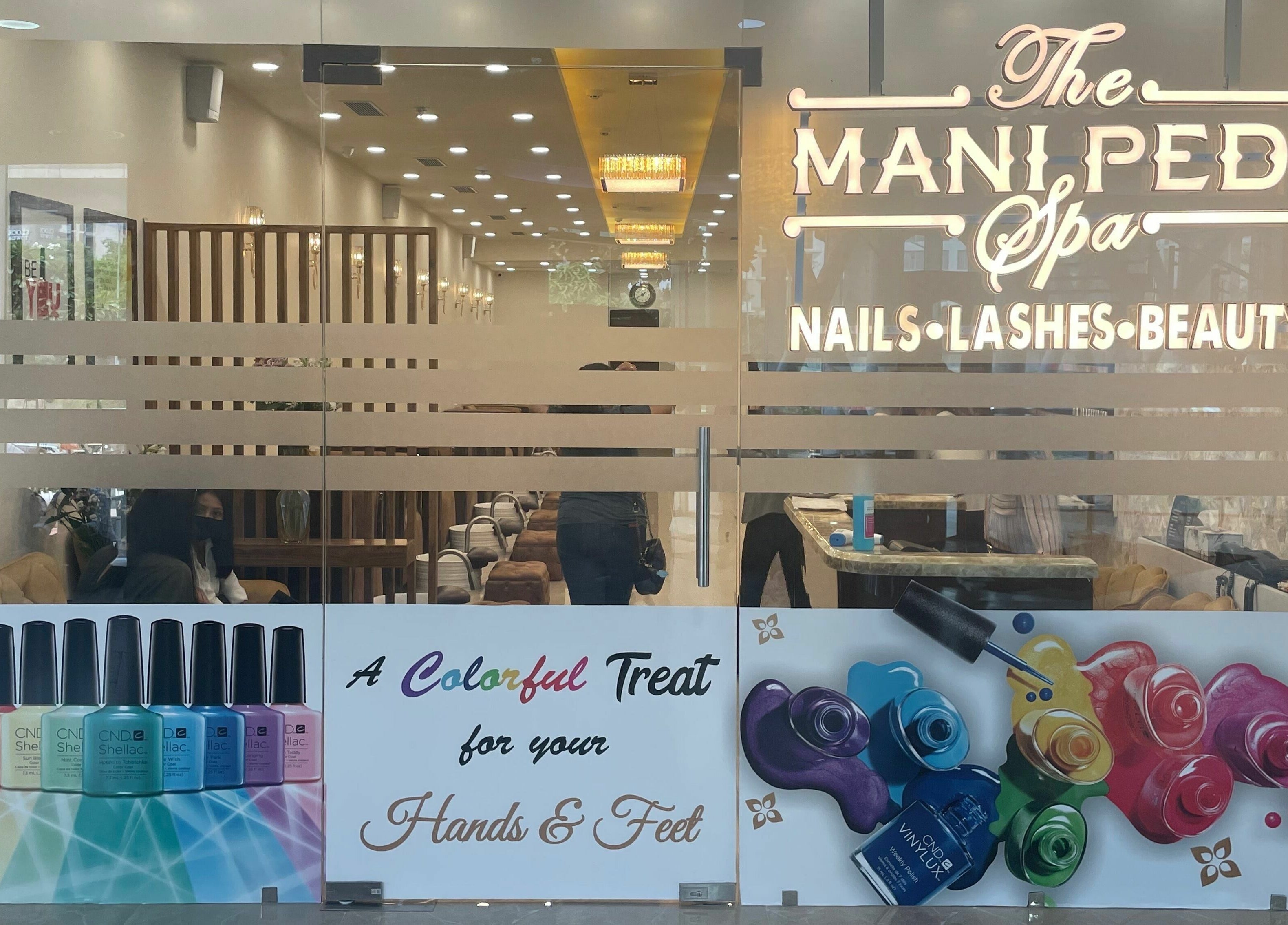 Entrance of The Mani Pedi Spa, South Point Mall, DLF 5, Gurugram, Haryana, IN, showcasing nail polish colors.