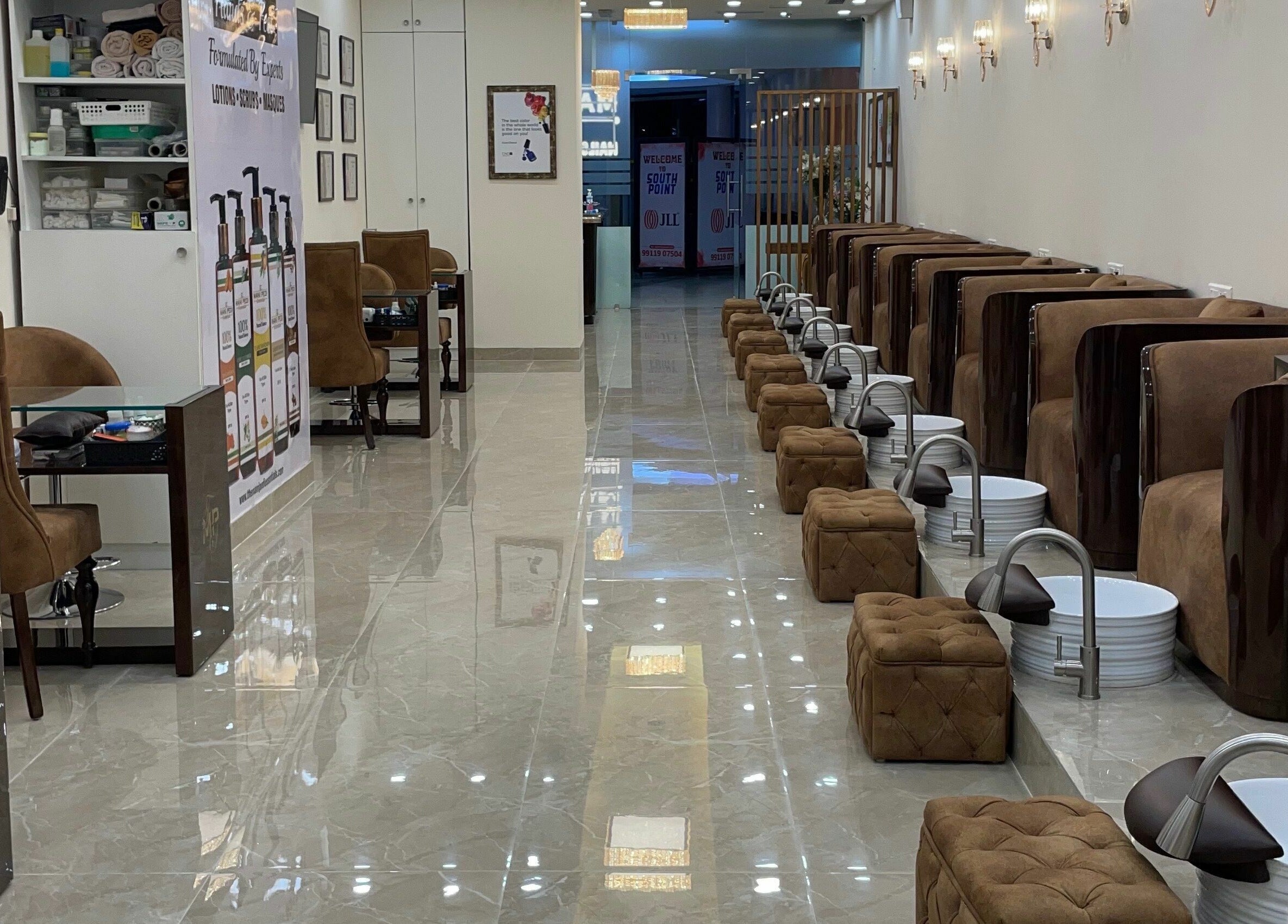 Elegant interior of The Mani Pedi Spa, South Point Mall, DLF 5, Gurugram, Haryana, IN showcasing plush seating and decor.
