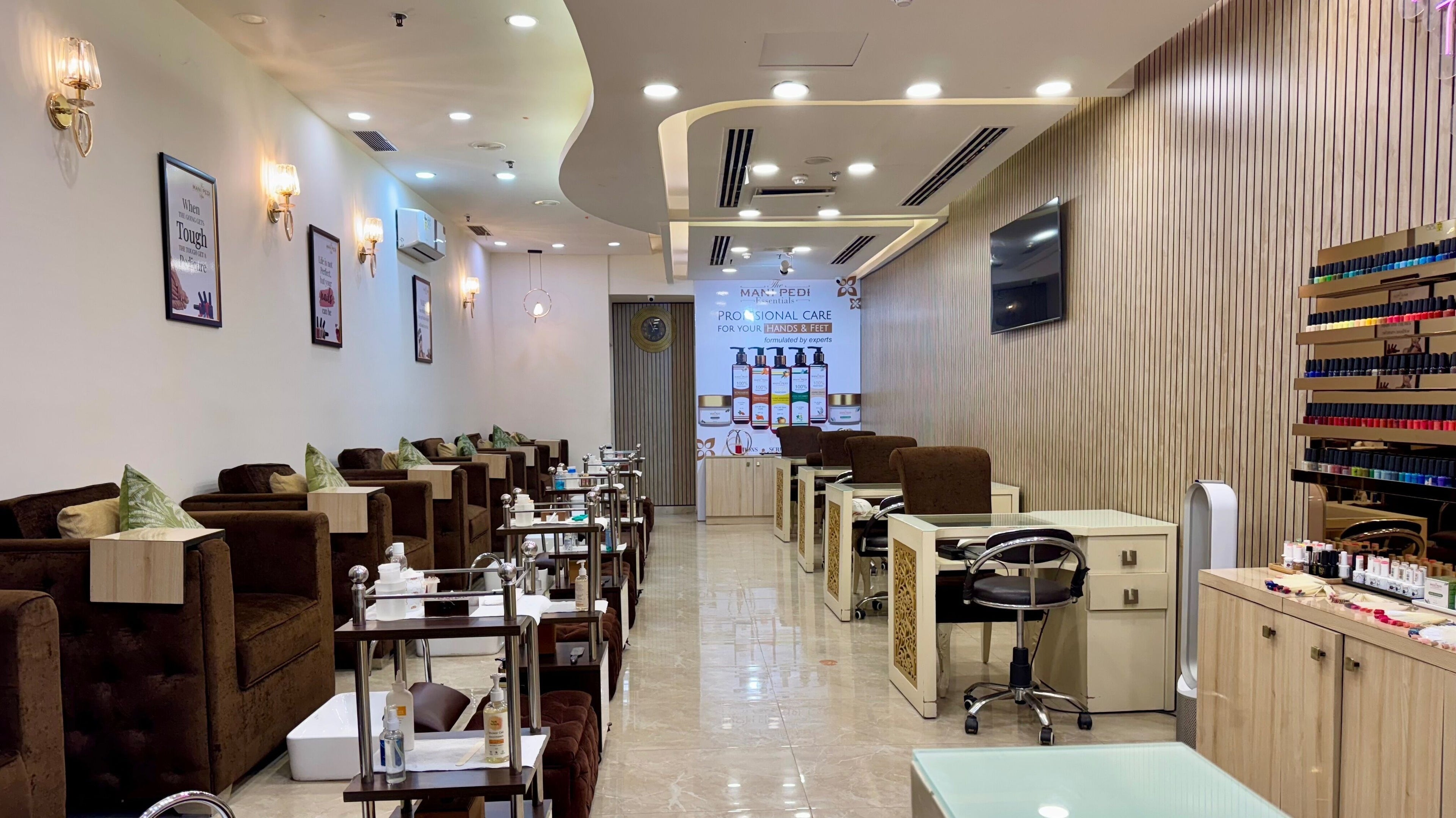 Luxurious interior of The Mani Pedi Spa - Sohna Road in Gurugram, Haryana, IN with plush seating and nail care stations.