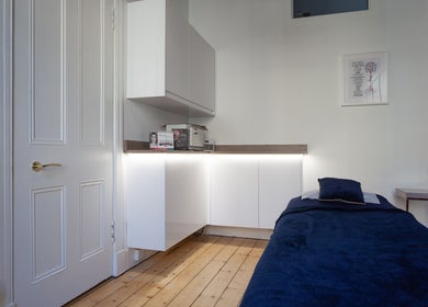 Cozy massage room at Soul Therapy Wellbeing, Edinburgh, Scotland, GB with a serene blue bed and elegant decor.