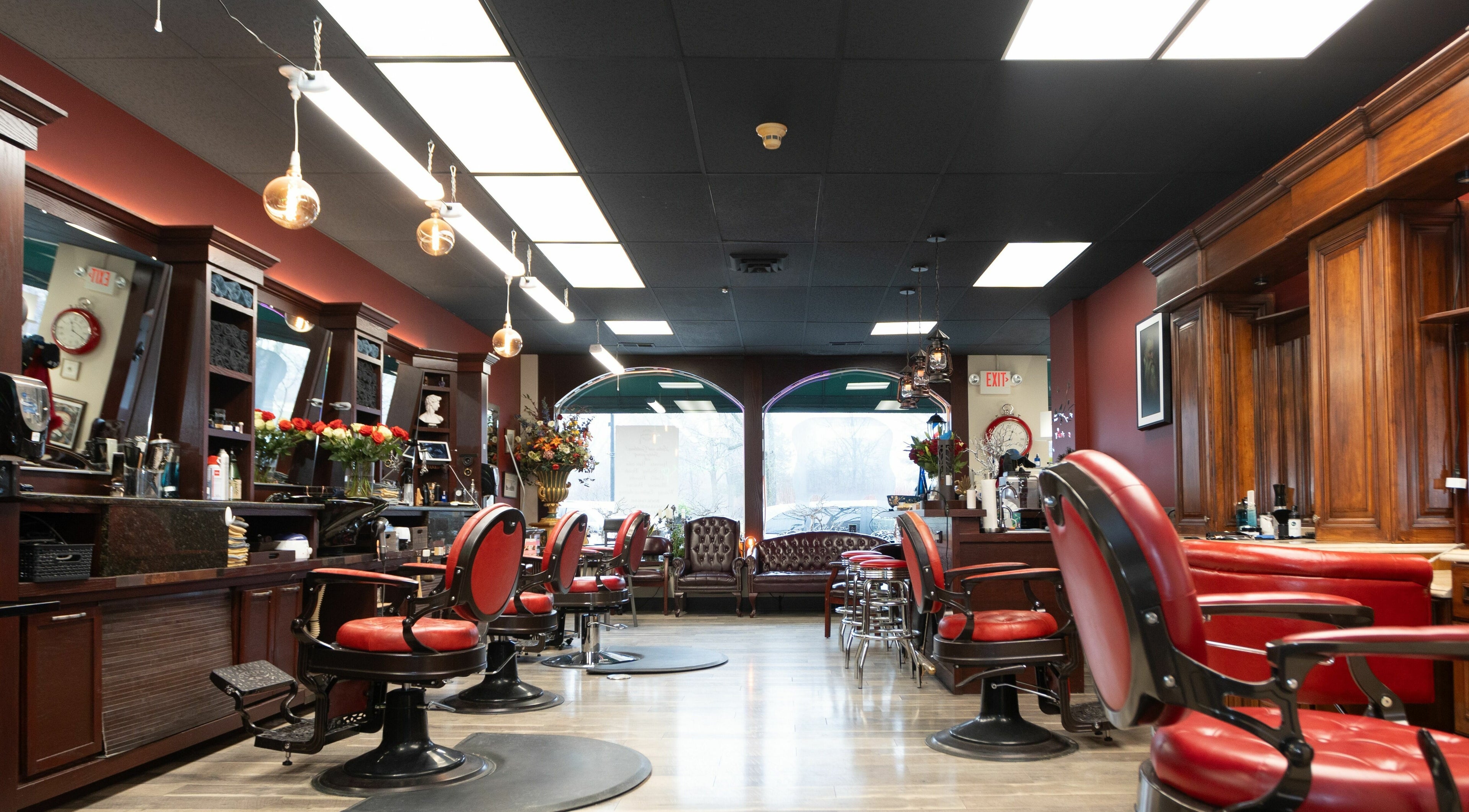 Elegant interior of Yana's Barbershop of Ravinia in Highland Park, Illinois, US. Features classic red chairs.