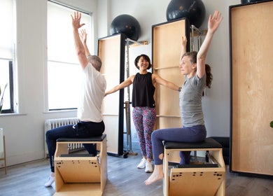 Clients enjoying a Pilates class at Tomoko Pilates NYC, New York, New York, US, with bright natural light.