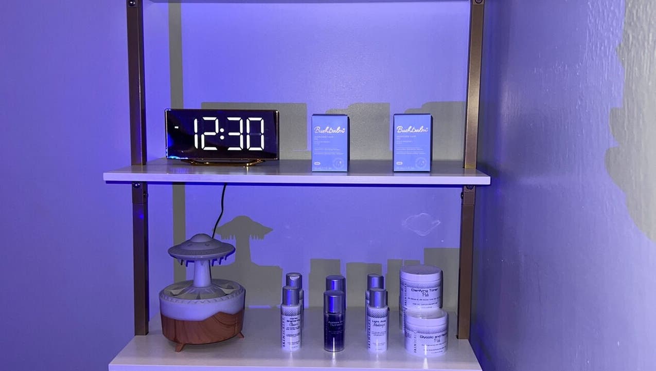 Skincare products on a shelf at Elixir Skyn, Nassau, New Providence, BS, highlighting a calming wellness ambiance.