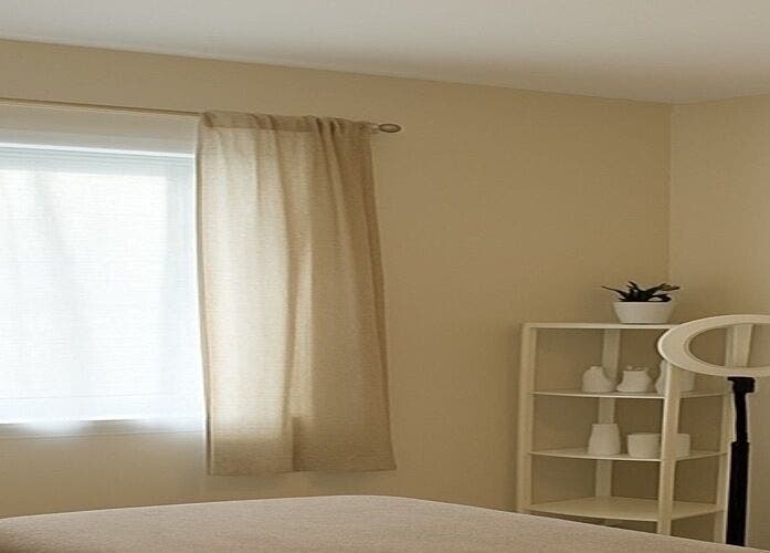 Relaxing treatment room at Elixir Skyn in Nassau, New Providence, BS with natural light and soothing decor.