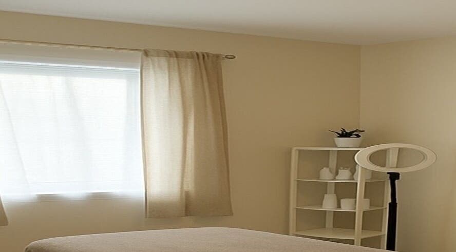 Relaxing treatment room at Elixir Skyn in Nassau, New Providence, BS with natural light and soothing decor.