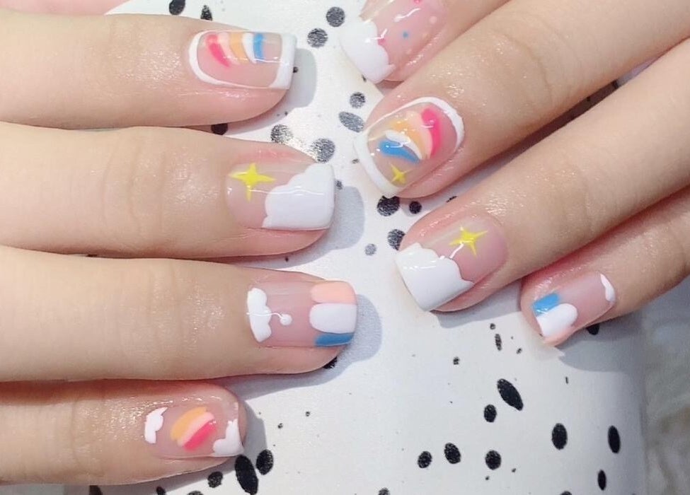 Colorful nail art at Solitude Nails Salon, Saskatoon, Saskatchewan, CA, showcasing vibrant rainbow designs.