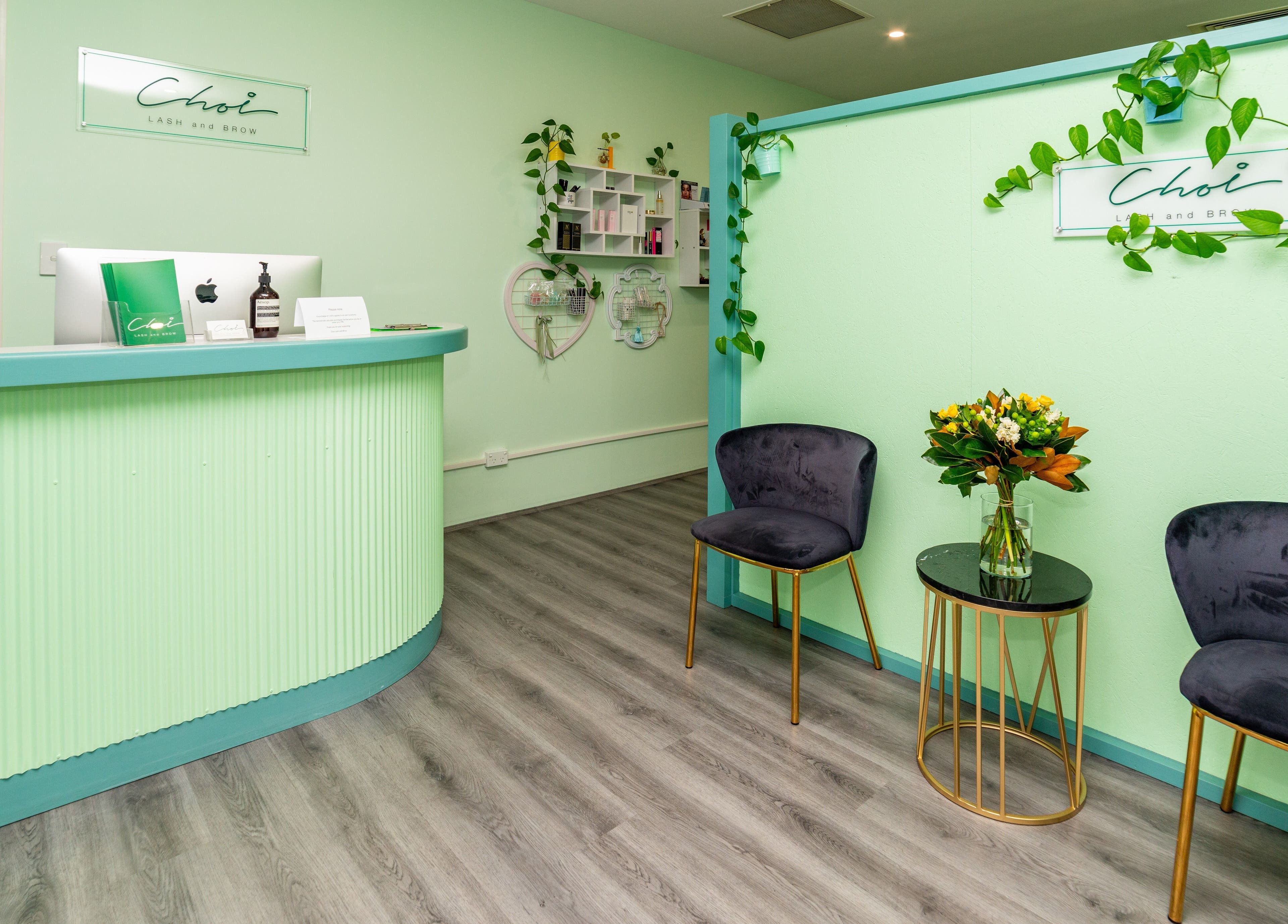 Stylish reception area of Choi Lash and Brow in Lane Cove, New South Wales, AU with green decor and elegant seating.