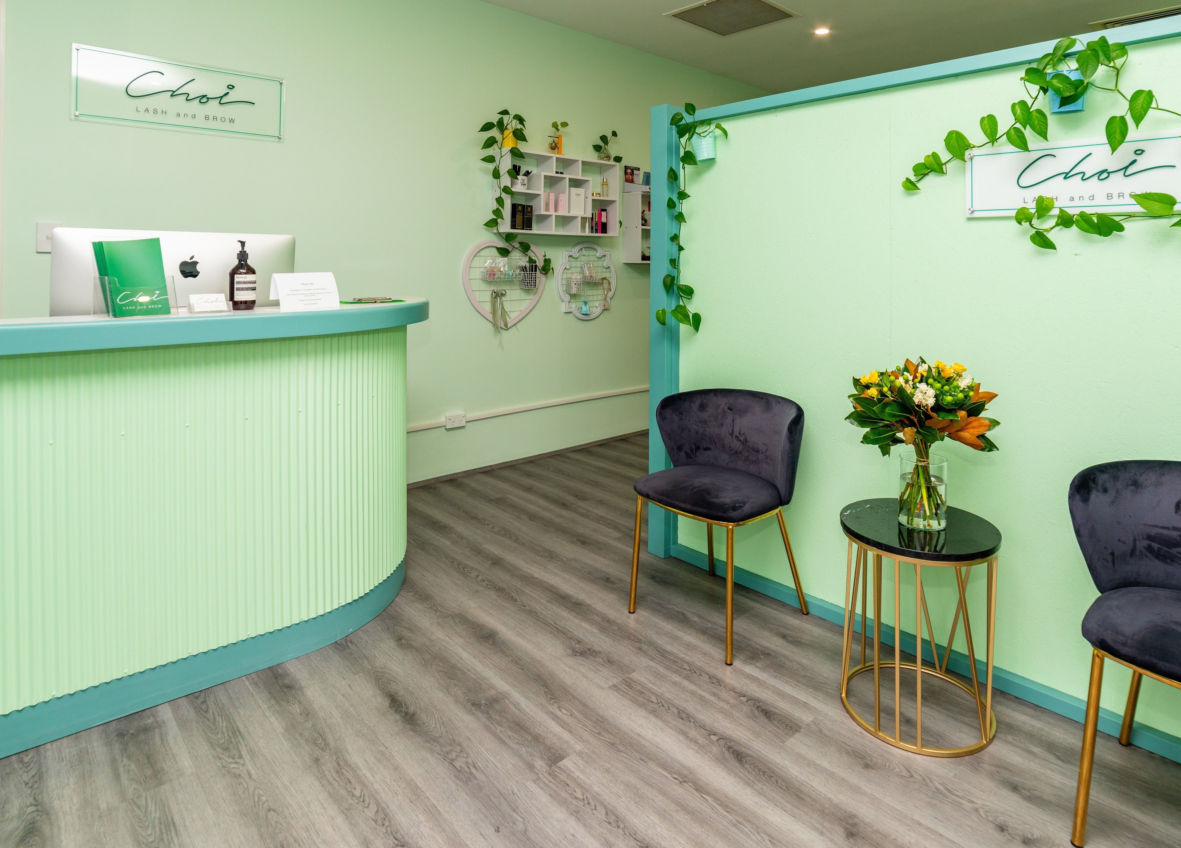 Stylish reception area of Choi Lash and Brow in Lane Cove, New South Wales, AU with green decor and elegant seating.