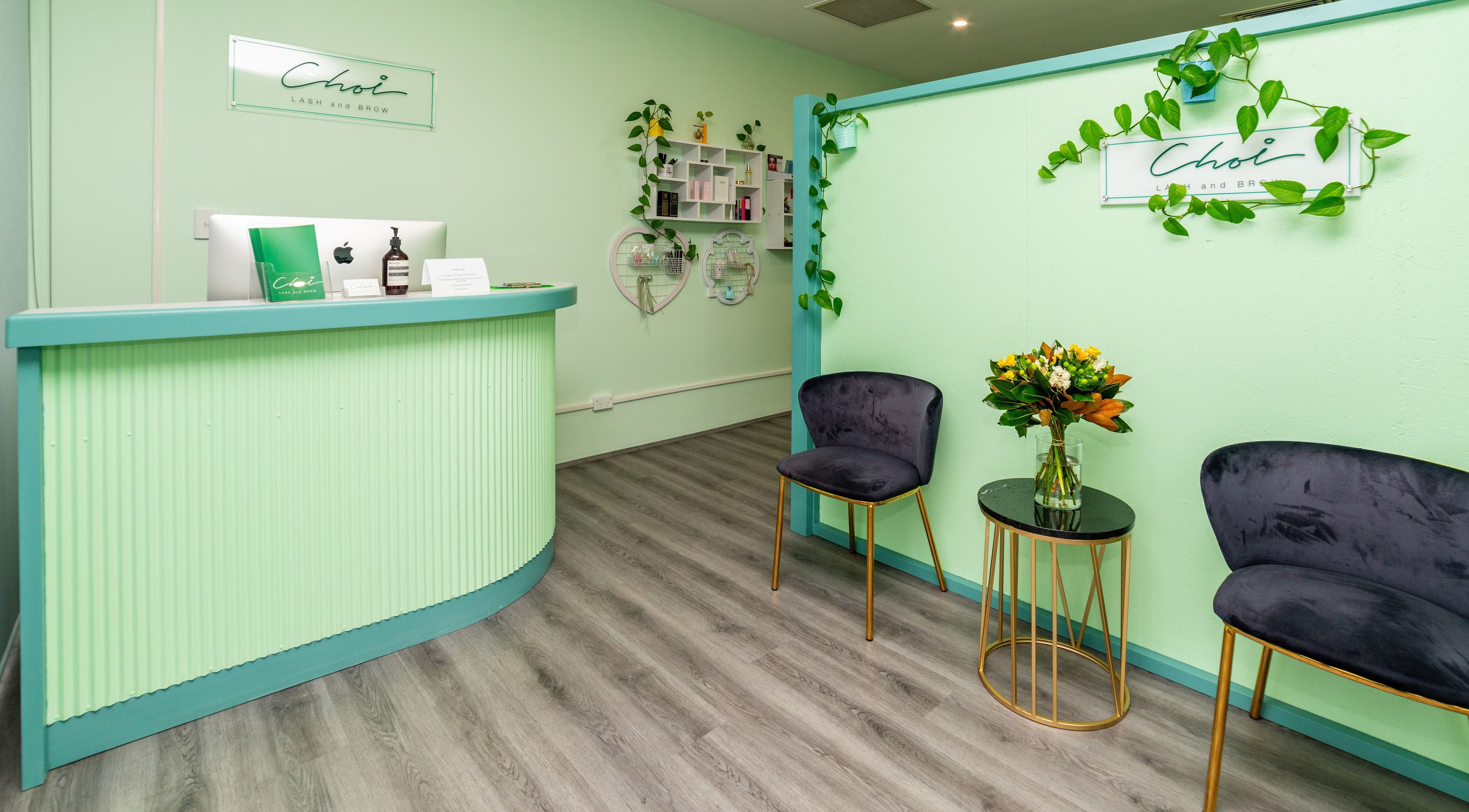 Stylish reception area of Choi Lash and Brow in Lane Cove, New South Wales, AU with green decor and elegant seating.