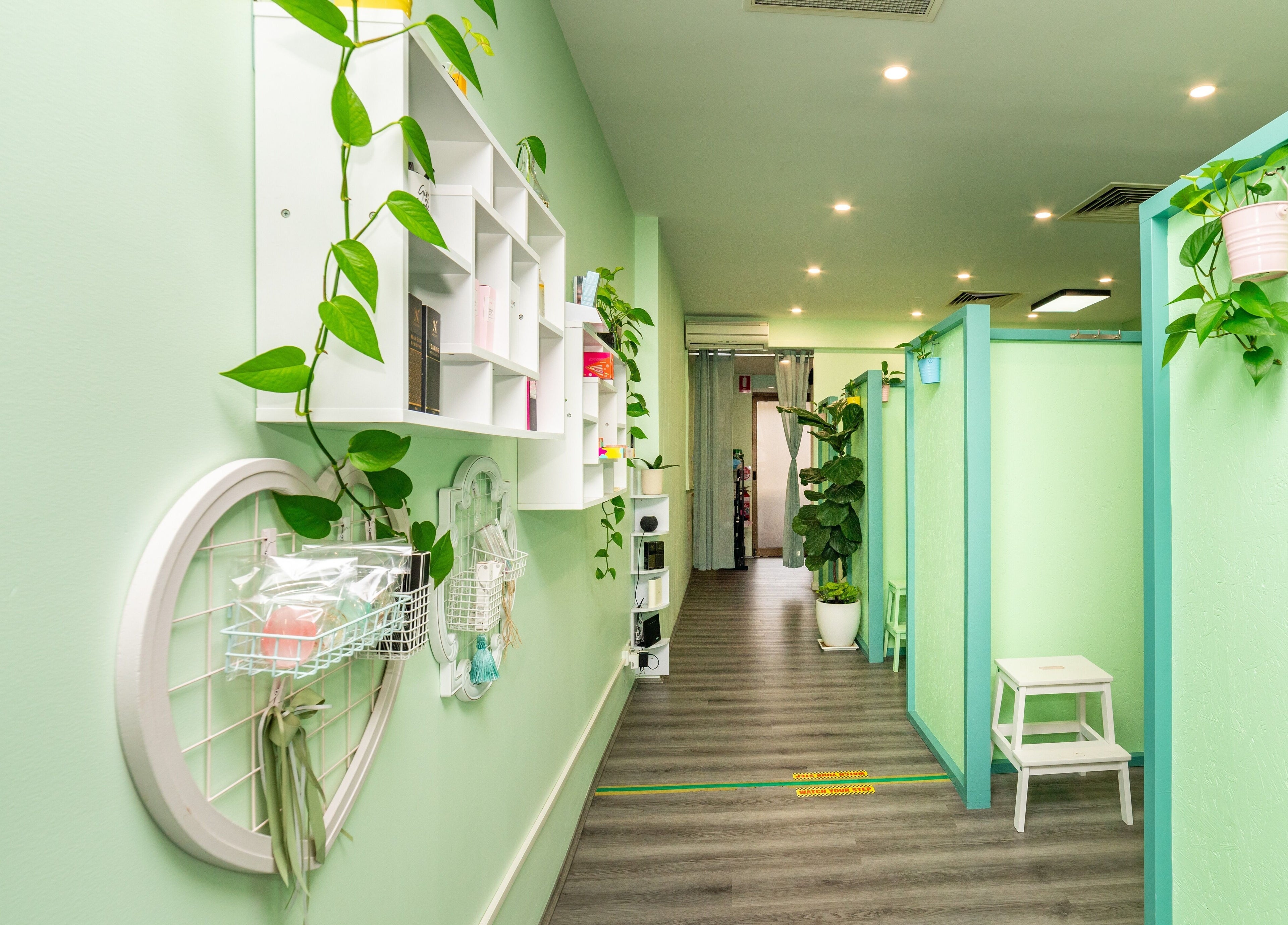 Choi Lash and Brow hallway with green walls and plants, Lane Cove, New South Wales, AU.