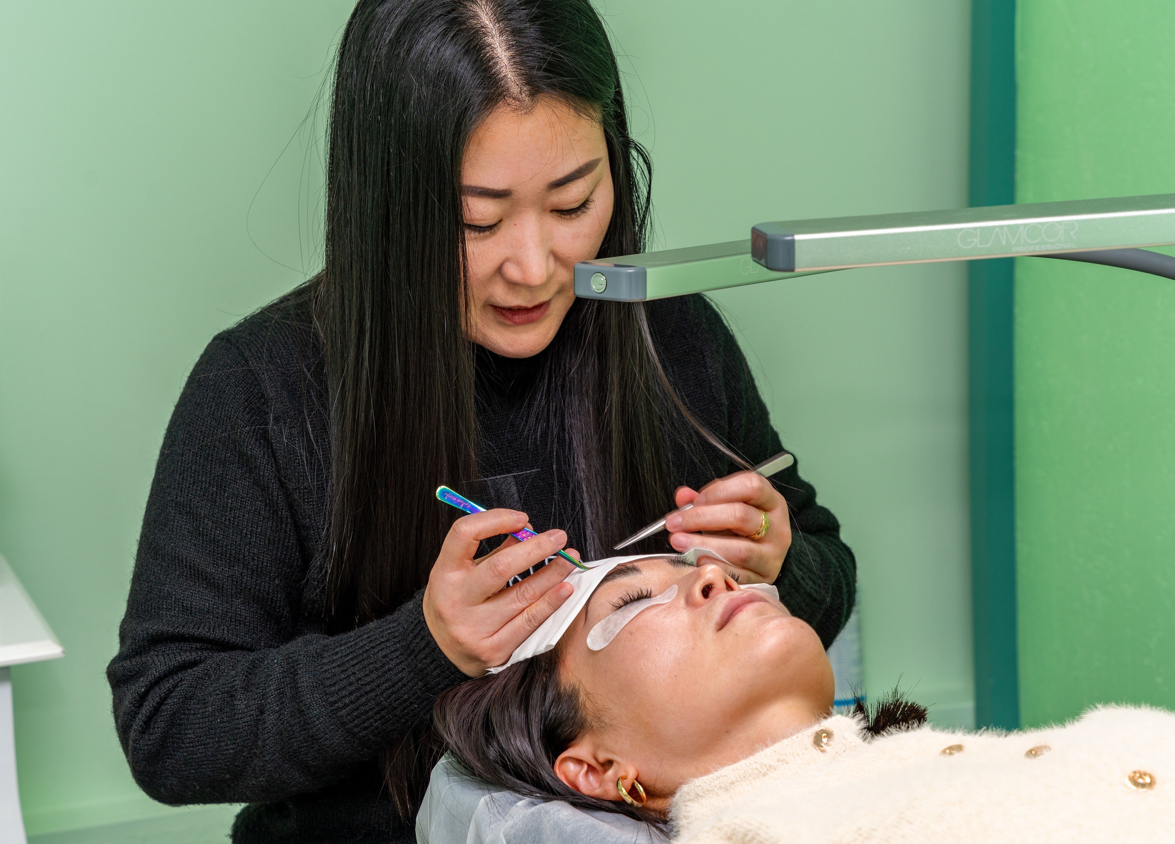 Lash technician at Choi Lash and Brow, Lane Cove, New South Wales, AU applying extensions.