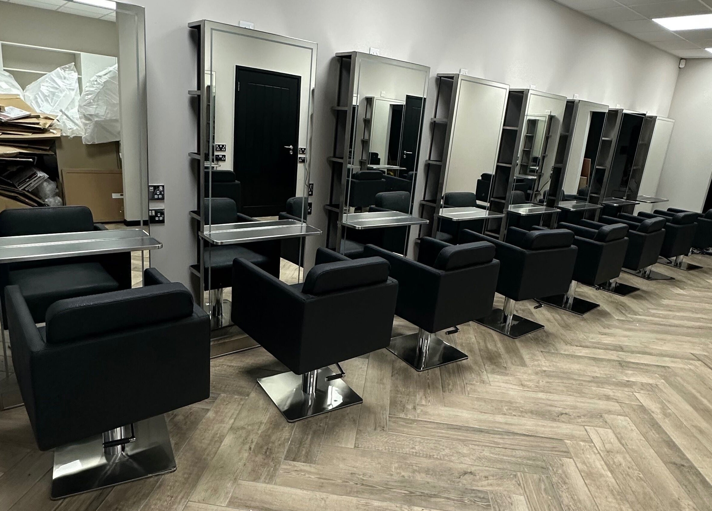 Modern salon chairs and mirrors at Gorgeous Melksham in Melksham, England, GB, showcasing sleek design.