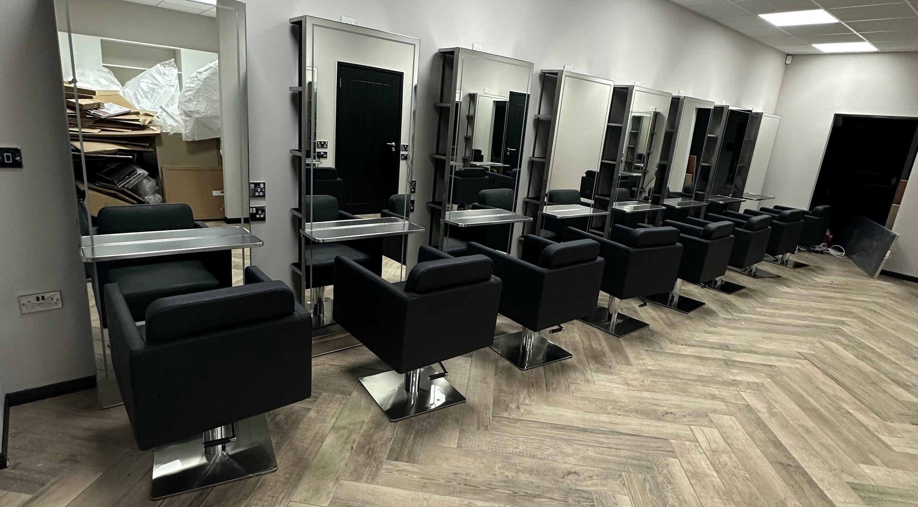 Modern salon chairs and mirrors at Gorgeous Melksham in Melksham, England, GB, showcasing sleek design.