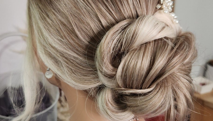 Chic updo style at Jes Harrington Hair, Ennismore, Ontario, CA. Intricately styled blonde hair.