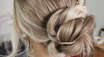 Chic updo style at Jes Harrington Hair, Ennismore, Ontario, CA. Intricately styled blonde hair.