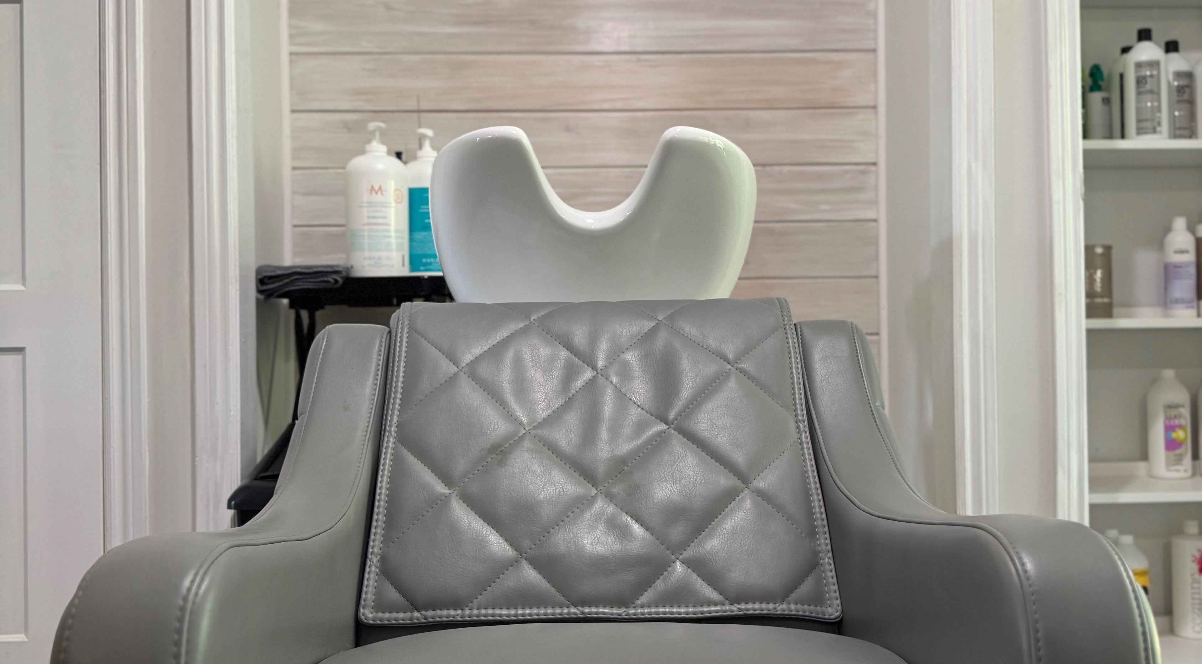 Modern salon chair and sink at Jes Harrington Hair, Ennismore, Ontario, CA, showcasing sleek elegance.