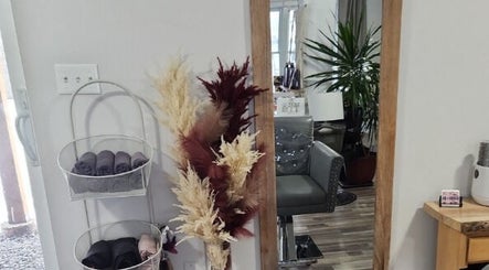 Elegant salon corner at Jes Harrington Hair, Ennismore, Ontario, CA, featuring a cozy chair and stylish decor.