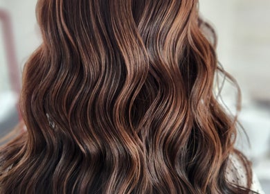 Elegant brown wavy hair styled at Jes Harrington Hair in Ennismore, Ontario, CA.