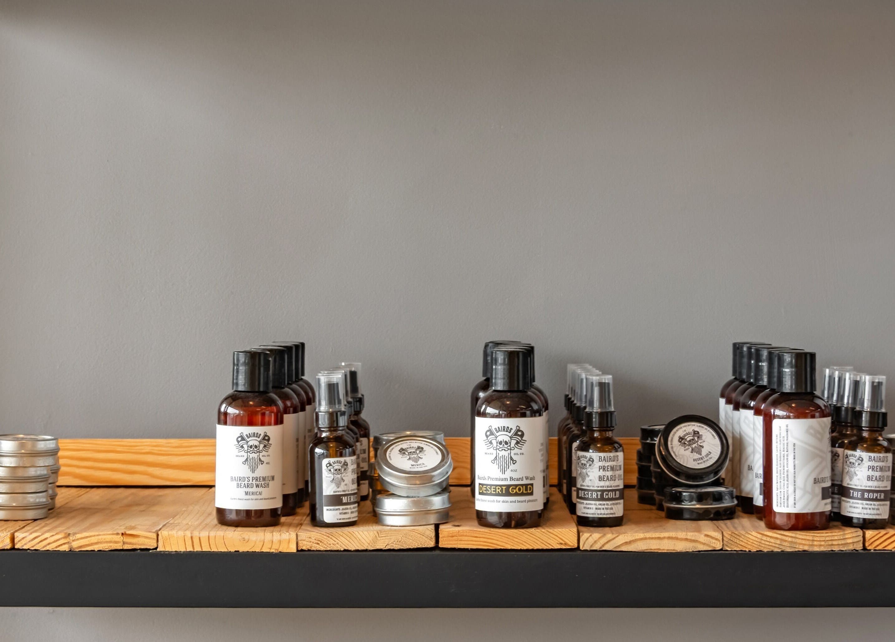 Grit Salon & Barbering in Pasco, Washington, US features premium beard care products on a wooden shelf.