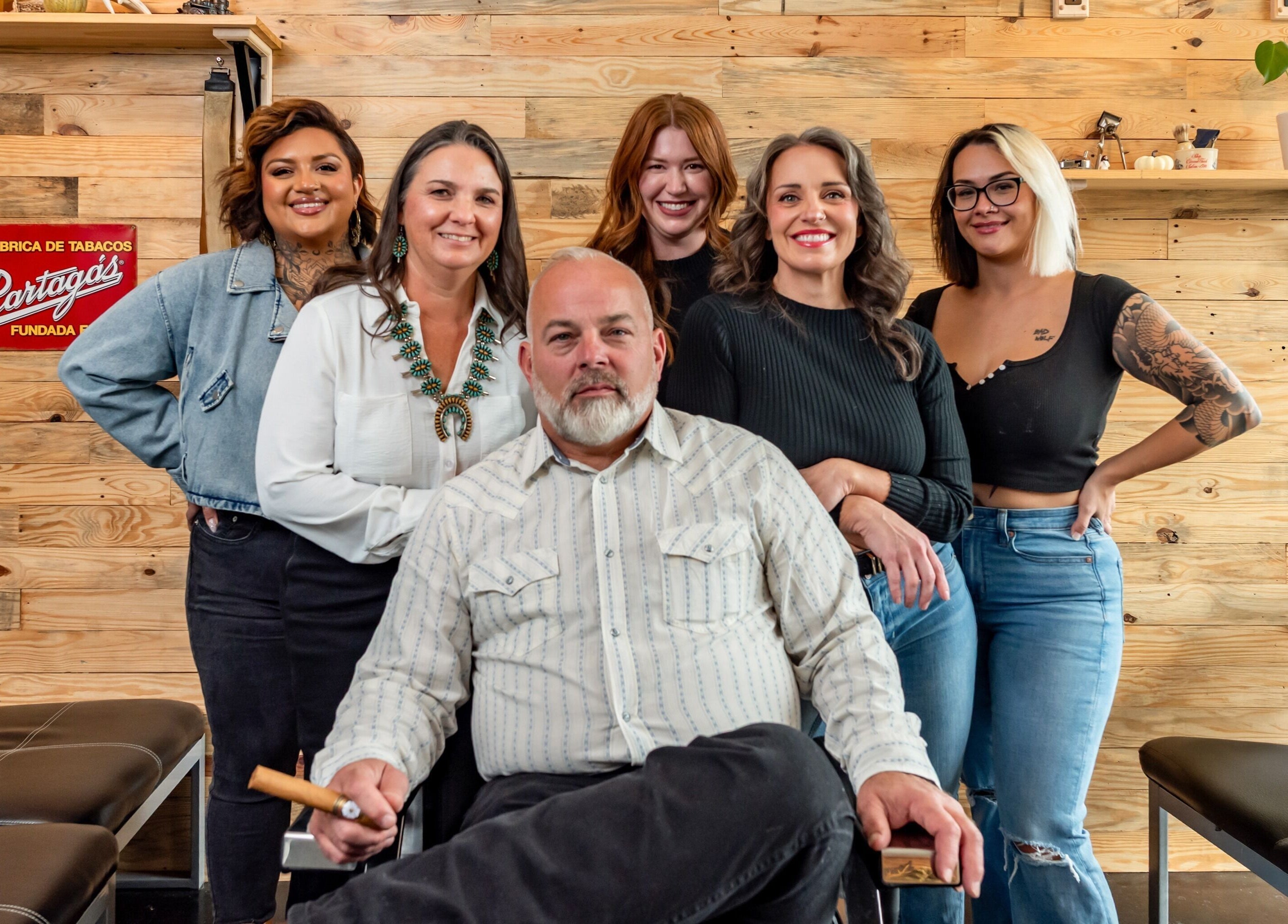 Team at Grit Salon & Barbering in Pasco, Washington, US, smiling in a chic and cozy setting.