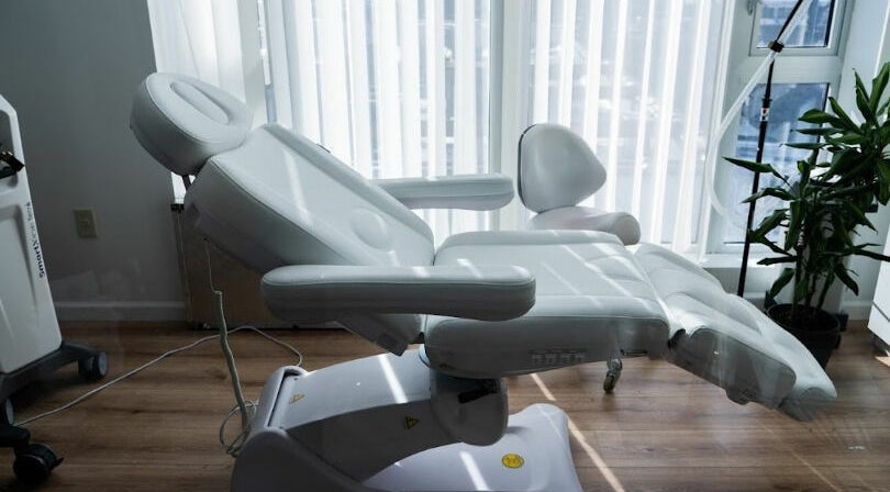 Luxurious treatment chair at AJ Laser and Spa, New York, New York, US, bathed in natural light.
