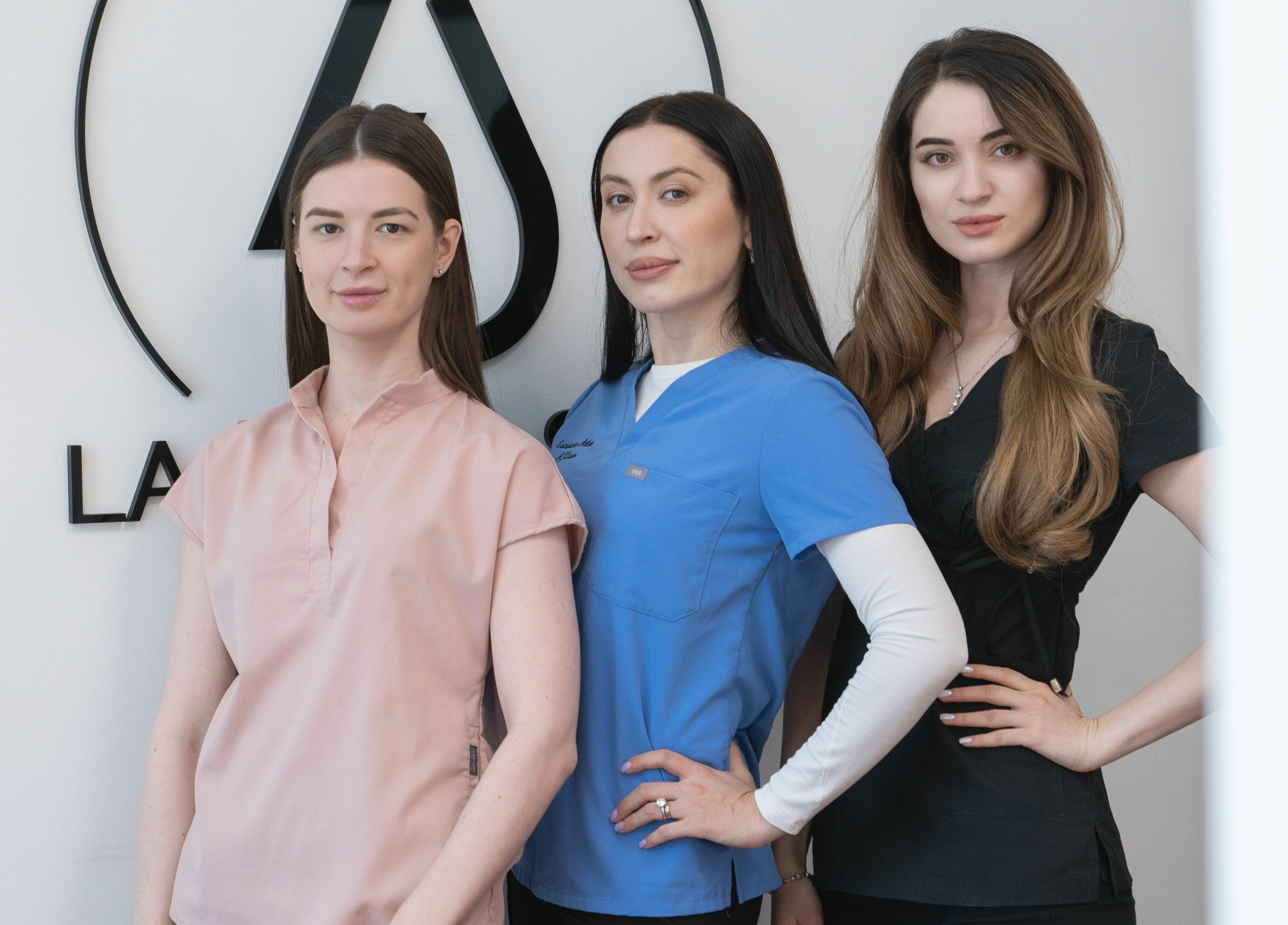 AJ Laser and Spa team members in uniform at New York, New York, US welcoming clients with confidence.