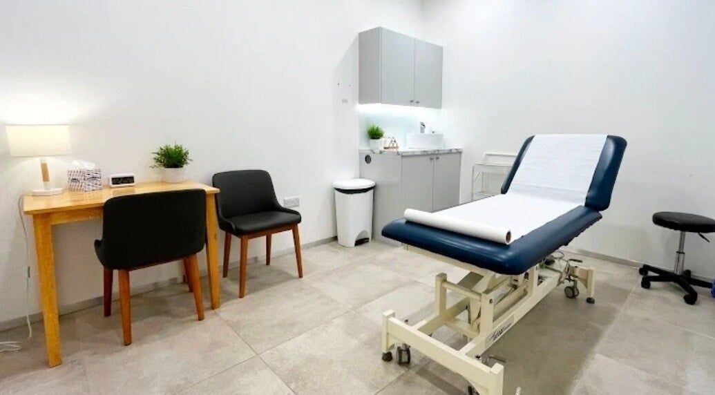 A serene treatment room at Celestial Treatments - City, London, England, GB, featuring a comfortable therapy bed.