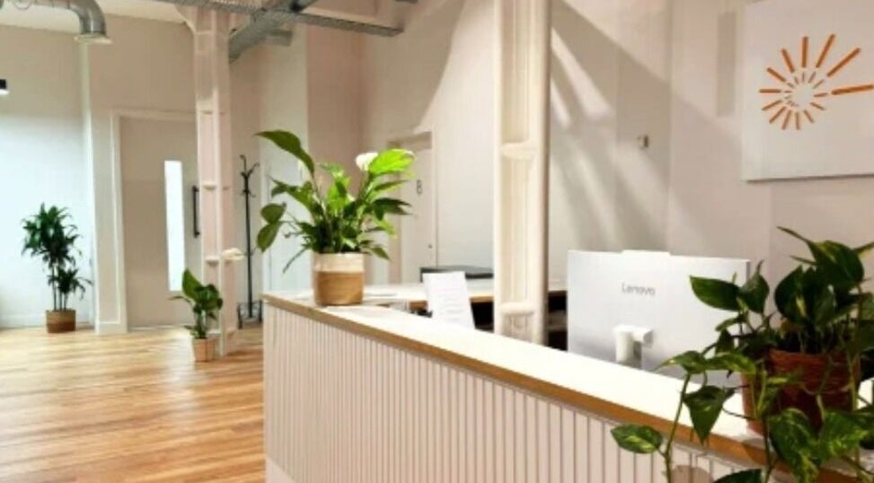 Lobby view of Celestial Treatments - City, London, England, GB with plants and wooden flooring.