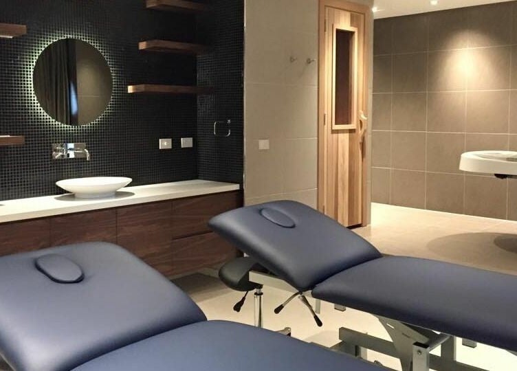 Modern spa room at Laurel Beauty And Spa | Docklands, Victoria, AU with massage tables and ambient lighting.
