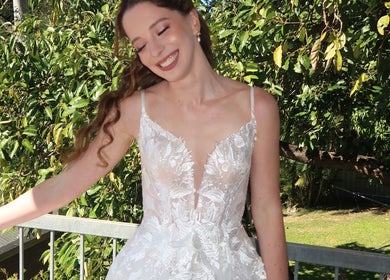 Bride in a radiant gown at Daphne's Artistry, Calamvale, Queensland, AU, glowing amidst lush greenery.