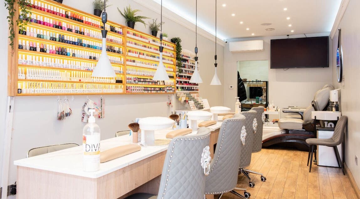 Interior of Angela’s Nails in London, England, GB showcasing a chic nail bar with elegant seating and polish display.