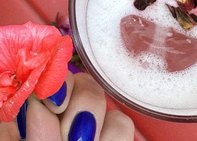 Vibrant blue nails holding floral drink at BeautyNailBar Beograd, RS, highlighting elegance and style.